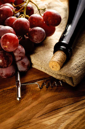 Red wine and grapes in vintage settingの写真素材