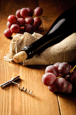 Red wine and grapes in vintage settingの写真素材