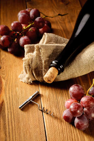 Red wine and grapes in vintage settingの写真素材