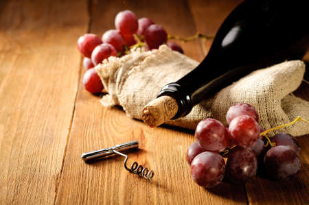 Red wine and grapes in vintage settingの写真素材