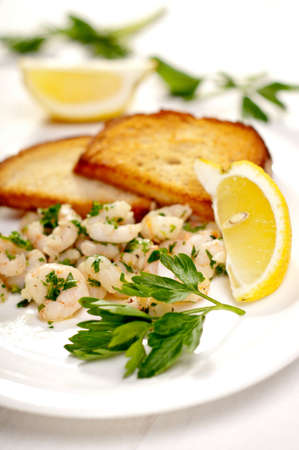 shrimp with parsley and garlic served with croutonsの写真素材