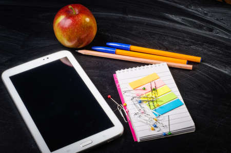 school supplies on the background of blackboard