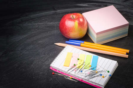 school supplies on the background of blackboard