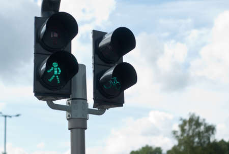 Pedestrian walkway sign with a green traffic lightの写真素材