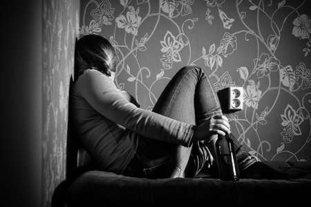 young sad girl drinking alcoholの写真素材