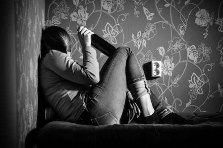 young sad girl drinking alcoholの写真素材