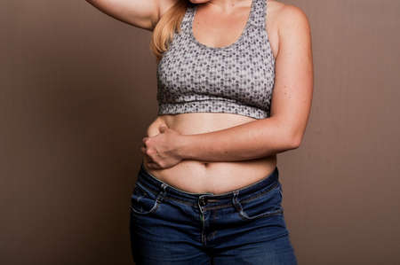 young girl shows her obesityの写真素材