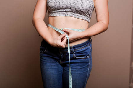 young girl shows her obesityの写真素材