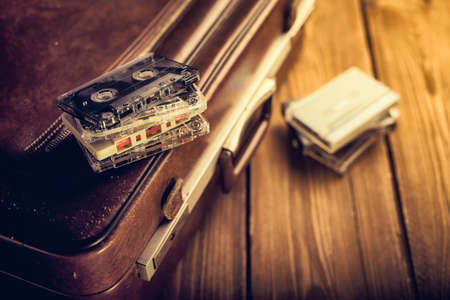 Cassette tape lying on an old suitcase. Vintage Retouchingの写真素材