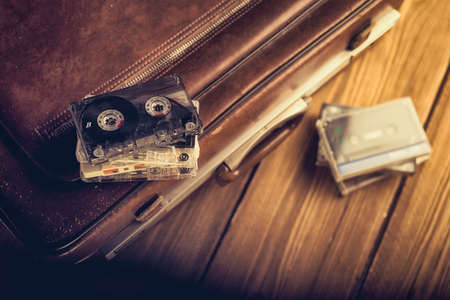 Cassette tape lying on an old suitcase. Vintage Retouchingの写真素材