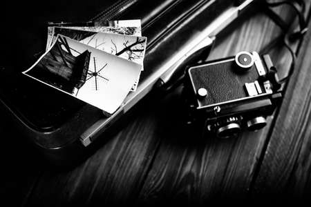 Old camera and old photos are on the case. Retouching in retro styleの写真素材