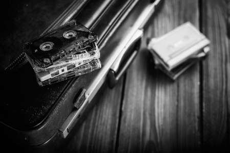 Cassette tape lying on an old suitcase. Vintage Retouching
