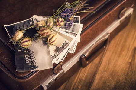 Old photographs, a camera and dried flowersの写真素材