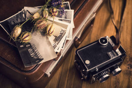 Old photographs, a camera and dried flowersの写真素材