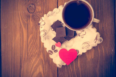 Coffee and chocolate, in the heart from the carton. Valentine\'s Day. Retouching in retro styleの写真素材