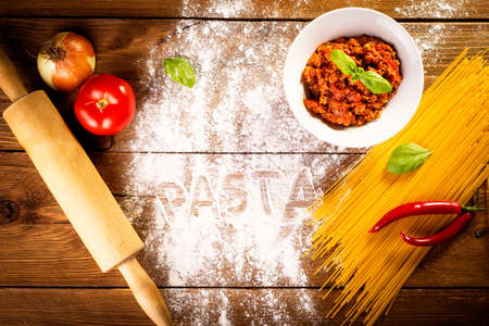 ingredients for spaghetti on a wooden tableの写真素材