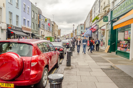 LONDON - MAY 31: People walking in Portobello Road, London, May 31, 2015. The road houses one of London's most notable street markets, also location for the movie "Notting Hill"のeditorial素材