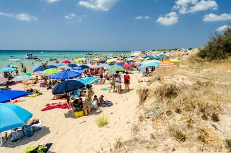 PESCOLUSE, ITALY - AUGUST 5: People enjoying a beautiful day at the beach in Pescoluse, Apulia, Italy, August 5, 2015. Aka the Maldives of Salento, it is one of the main attractions in the regionのeditorial素材