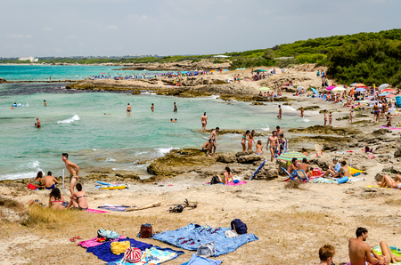 GALLIPOLI, ITALY - AUGUST 4: People enjoying a beautiful day at the beach in Punta della Suina near Gallipoli, Apulia, Italy, August 4, 2015.のeditorial素材