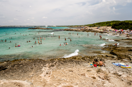 GALLIPOLI, ITALY - AUGUST 4: People enjoying a beautiful day at the beach in Punta della Suina near Gallipoli, Apulia, Italy, August 4, 2015.のeditorial素材