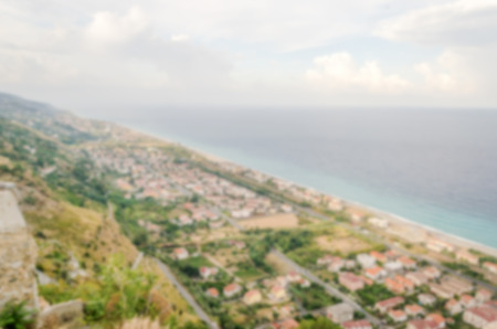 Defocused background with a scenic aerial view over the coastline in Calabria, Italy. Intentionally blurred post production for bokeh effectの写真素材