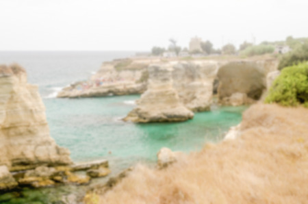 Defocused background with scenic rocky cliffs in Salento, Italy. Intentionally blurred post production for bokeh effectの写真素材
