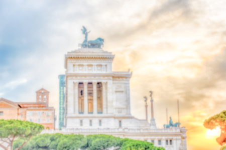 Defocused background with the iconic Altar of the Fatherland, scenic profile at sunset in Rome,...