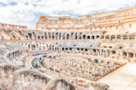 Defocused background with Interior of the Flavian Amphitheatre, aka Colosseum in Rome, Italy. Intentionally blurred post production for bokeh effectの写真素材
