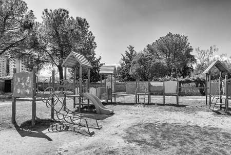 Deserted playground for kids inside a urban public park in Italy