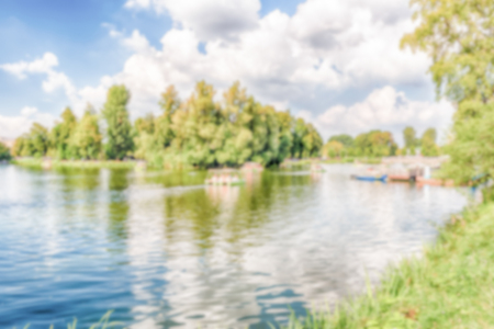 Defocused background with idillic lake inside Gorky Park, Moscow, Russia. Intentionally blurred post production for bokeh effectの写真素材