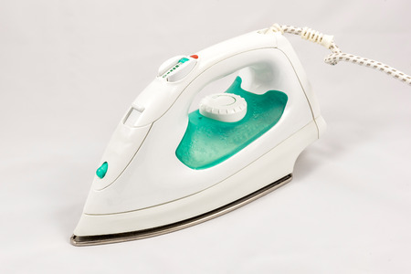 Electric steam flat iron, isolated on white backgroundの写真素材