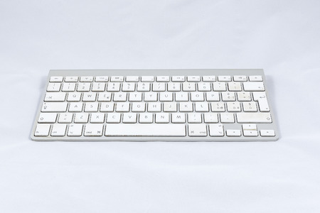 White wireless computer keyboard isolated on white background