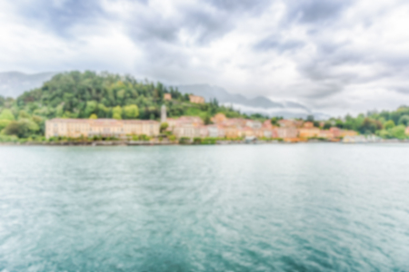 Defocused background with scenic view at dusk with waterfront of Bellagio town on the Lake Como, Italy. Intentionally blurred post production for bokeh effectの写真素材