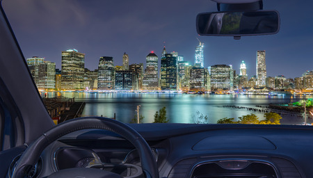 Looking through a car windshield with view of Manhattan skyline at night, New York City, USAの写真素材