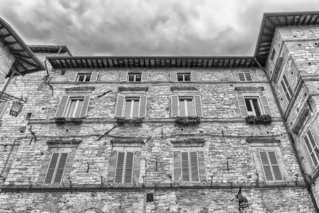 Historical buildings in the old city center of Assisi, one of the most beautiful medieval towns in central Italyの写真素材