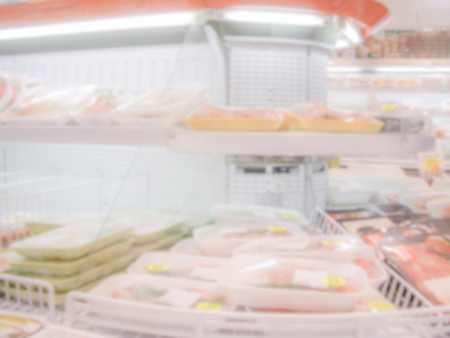 Defocused background with shelves full of grocery goods in a supermarket or hypermarket convenience store. Intentionally blurred post production for bokeh effectの写真素材