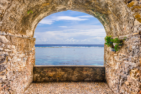 Scenic rock arch balcony overlooking a tropical beach in Moorea, French Polynesiaの写真素材