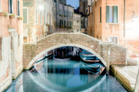 Defocused background with view at night over a scenic canal, Venice, Italy. Intentionally blurred for bokeh effectの写真素材