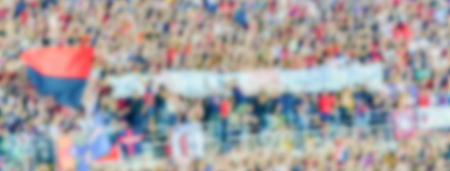 Defocused background with supporters in the stadium for football match. Intentionally blurred post production for bokeh effectの写真素材