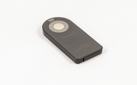 Small black unbranded remote control for DSLR camera, isolated on a white backgroundの写真素材