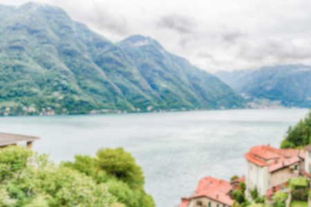 Defocused background with scenic landscape over the Lake Como, as seen from the town of Bellano, Italy. Intentionally blurred post production for bokeh effectの写真素材