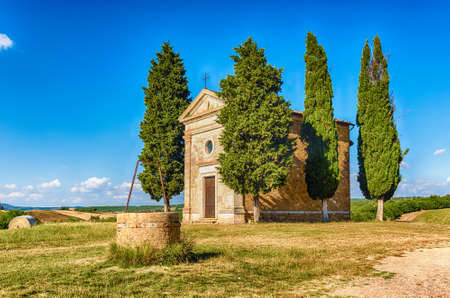 SAN QUIRICO D'ORCIA, ITALY - JUNE 23: The chapel of Madonna di Vitaleta, iconic building in the countryside of San Quirico d'Orcia, in the province of Siena, Italy, as seen on June 23, 2019のeditorial素材