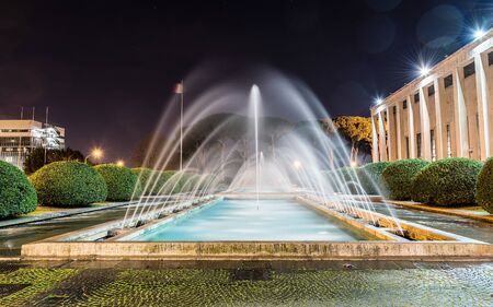 Scenic fountain, iconic neoclassical architecture in the EUR district, Rome, Italyの写真素材