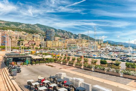 View over luxury yachts and apartments of Port Hercules in La Condamine district, city centre and...