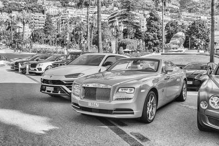 MONTE CARLO, MONACO - AUGUST 13: Luxury cars parked in Place du Casino, where the famous gambling and entertainment complex opened in 1863, located in the Principality of Monaco, as of August 13, 2019のeditorial素材