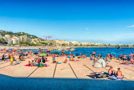 CANNES, FRANCE - AUGUST 15: People enjoying a sunny day on the beach in Cannes, Cote d'Azur, France, as seen on August 15, 2019のeditorial素材