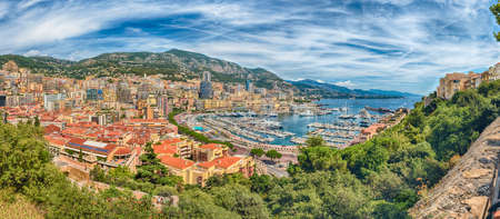 Panoramic view over luxury yachts and apartments of Port Hercules in La Condamine district, city...