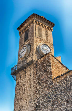 Clock and Belltower of the Church of Our Lady of Esperance, one of the major landmarks in Le Suquet medieval district in Cannes, Cote d'Azur, Franceの写真素材