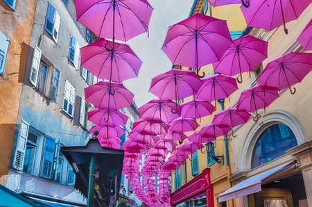 Iconic pink umbrellas decorating the city streets in the historic center of Grasse, Cote d'Azur, Franceの写真素材