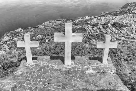 The iconic Three Crosses on the top of Mount Sant'Elia overlooking the town of Palmi on the Tyrrhenian Sea, Italyの写真素材